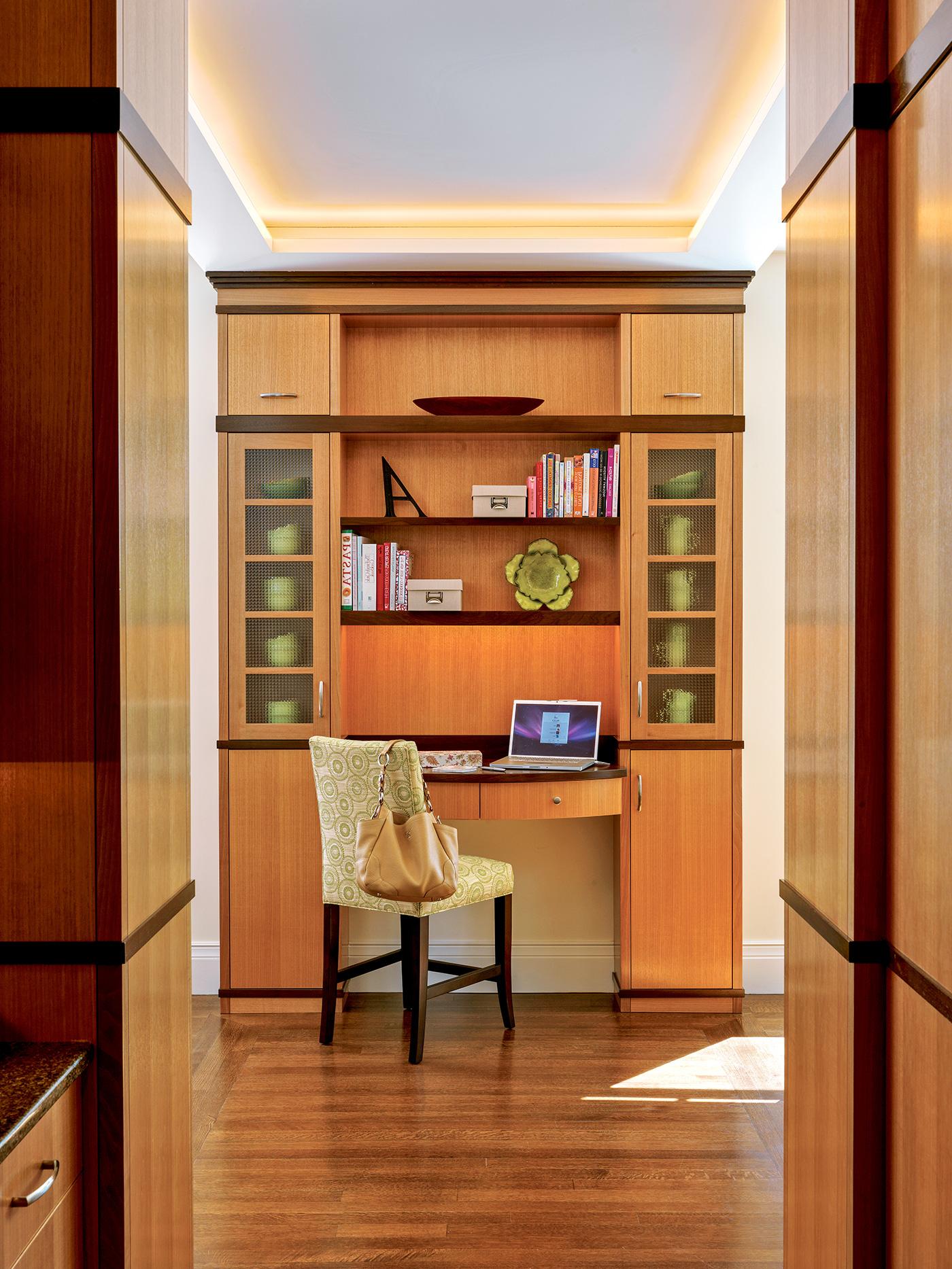 Home office space with custom millwork in a hallway design by Nicholaeff Architecture + Design
